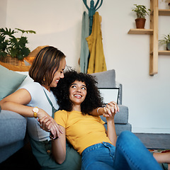 Image showing Lesbian, couple and relax on couch in communication at home for support, trust and partnership. Happy lgbt woman, living room or smile for identity or equality love in house, commitment or together