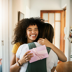 Image showing Excited, happy hug and present for birthday of girl friends and smile from kindness. Surprise, gift and female person at home with giving in lounge with celebration, congratulations and package