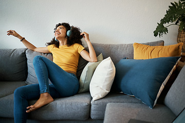 Image showing Happy, freedom and woman on a sofa with music, headphones or subscription at home. Podcast, earphones and female person having fun with radio, streaming or online audio, track or album in living room