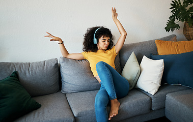 Image showing Music, headphones and woman dance on a sofa with podcast, album or audio track at home. Radio, earphones and female person having fun in living room with feel good subscription, streaming or freedom