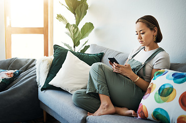 Image showing Woman, relax on sofa with smartphone and chat online with communication, wellness and reading text message. Email, technology and mobile app with virtual conversation, typing on social media at home