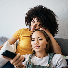 Image showing Love, relax and an LGBT couple watching tv on a sofa in the living room of their home together. Lesbian, remote and a woman with her girlfriend enjoying a movie on a subscription streaming service