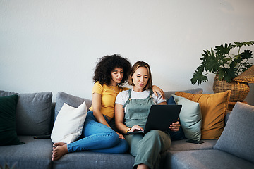 Image showing Tablet, love and lesbian couple relaxing on a sofa in the living room networking on social media. Rest, digital technology and young lgbtq women scroll on mobile app or the internet together at home.