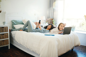 Image showing Relax, technology and morning with a lesbian couple in the bedroom together in their home on the weekend. Diversity, smile and a happy young lgbt woman with her girlfriend in the bedroom for love