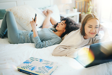 Image showing Relax, laptop and social media with a lesbian couple in bed together in their home on the weekend. Diversity, smile and a happy lgbt woman with her girlfriend in the bedroom for love in the morning