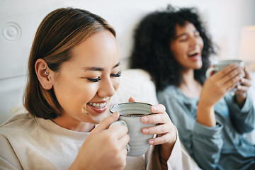 Image showing Coffee, smile and lesbian couple on bed in conversation for bonding and relaxing together. Happy, rest and interracial lgbtq women laughing, talking and drinking latte in bedroom of modern apartment.