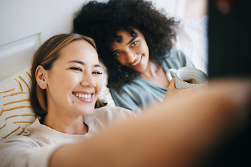 Image showing Love, selfie and lesbian couple relaxing on bed for bonding together in the morning on weekend. Smile, happy and young interracial lgbtq women taking a picture in bedroom of modern apartment or home.