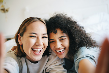 Image showing Love, selfie and portrait of lesbian couple on bed for bonding, resting or relaxing together. Smile, happy and young interracial lgbtq women taking a picture in bedroom of modern apartment or home.