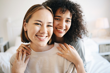 Image showing Smile, happy and portrait of lesbian couple on bed for bonding, resting or relaxing together on weekend. Love, romance and young interracial lgbtq women in the bedroom of modern apartment or home.