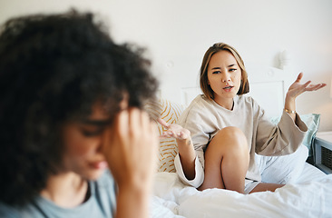 Image showing Women, lgbt couple and arguing in bed, home and talking with frustration, stress and headache. Communication, choice and sad for relationship, problems and fight for love, conversation and conflict