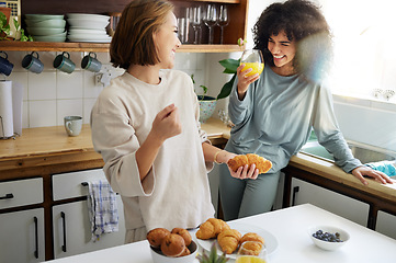 Image showing Couple, happiness and women with juice and cooking in kitchen for breakfast, nutrition and vitamin c in morning. Food, people and smile with drink and pajamas or natural face for wellness or fruit