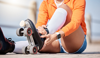 Image showing Woman, hands and shoes to roller skate outdoor for exercise, workout or training with wheels on sidewalk or ground. Start, sport and person with cardio, fitness or rollerskating gear in summer