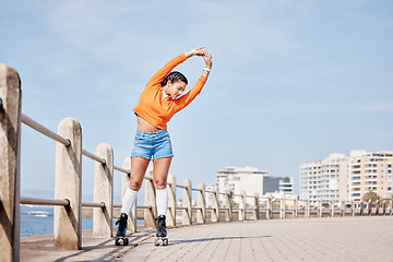 Image showing Roller skate, stretching and banner with a girl at the promenade on a blue sky background for the weekend. Fitness, beach and balance with a young person skating outdoor during summer on mockup space