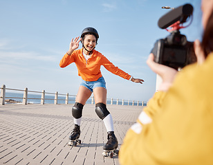 Image showing Girl, rollerskates and smile for camera, boardwalk and fun by ocean, sea and outdoors for hobby. Active person, skating and sport in summer, protection and gear for safety, energy and happy in summer