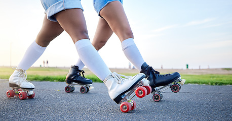 Image showing Feet, roller skates and closeup in park, street and outdoor for training, fitness or friends in summer. People, together and skating shoes on asphalt road for exercise, workout or moving for wellness