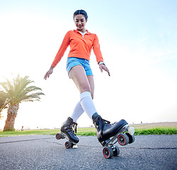 Image showing Happy, woman and skating outdoor on sidewalk with wheel, shoes and legs in cardio, exercise or summer workout. Fitness, training and girl roller skate on beach pavement, ground or balance on feet