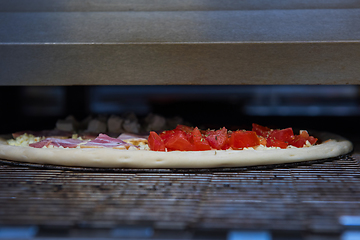 Image showing Preparing pizza in oven