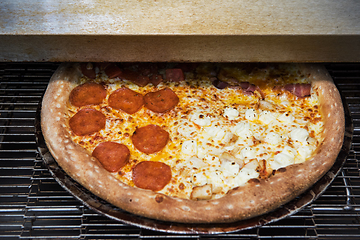 Image showing Preparing pizza in oven