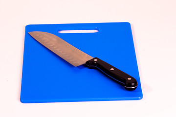 Image showing Santoku Knife on a Blue Cutting Board