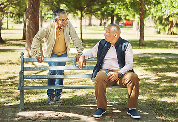 Image showing Senior friends, men and relax at park bench, talk and bonding outdoor with phone. Elderly people sitting together in garden, communication and serious conversation in nature for retirement in spring