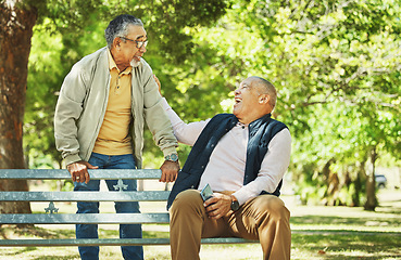 Image showing Elderly friends, laughing and relax at park bench, talking and bonding outdoor in retirement. Funny, smile and senior men sitting together in garden, communication and support to comfort in nature