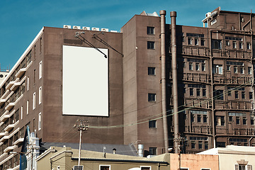 Image showing Building, mockup space and advertising billboard, commercial product or logo design in city. Empty poster for brand marketing, multimedia and communication with announcement, urban and banner outdoor