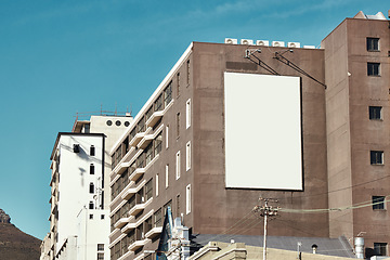 Image showing Building, mockup space and advertising banner, commercial product or logo design in city. Empty poster for brand marketing, multimedia and communication with announcement, urban and billboard outdoor