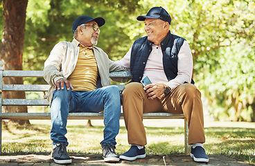 Image showing Senior friends, smile and relax on park bench, talking and bonding outdoor in retirement. Happy elderly men sitting together in garden, communication and chat in nature in the morning with phone.