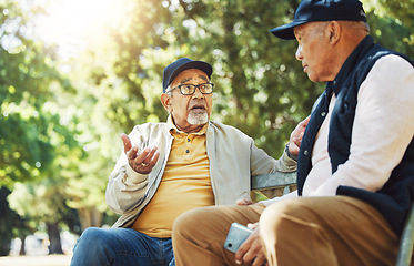 Image showing Senior friends, men and conversation on park bench, bonding and relax outdoor with phone. Elderly people sitting together in garden, communication and serious in nature for retirement in the morning