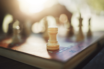 Image showing Closeup, chess and hand at park for competition, strategy and moving silhouette in sunshine. Person, vintage board game and outdoor for contest, battle and problem solving with challenge in summer