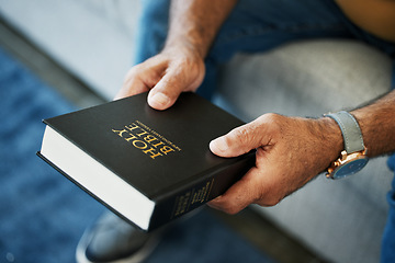 Image showing Bible, book and hands of man in home with study of Christian faith, religion or spirituality knowledge. Holy, worship and person with gospel, scripture or learning about God or story of Jesus Christ