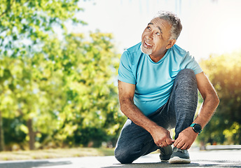 Image showing Tying laces, man and in a park for running, exercise and getting ready for outdoor cardio. Smile, idea and a mature or senior male athlete with shoes in the street for a workout, exercise or training