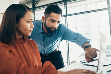 Image showing Creative people, laptop and pointing in coaching, teamwork or collaboration together at office. Man helping or training woman or staff on computer in project startup, ideas or strategy at workplace