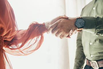 Image showing Creative people, handshake and teamwork in meeting, b2b deal or partnership together at office. Closeup of man and woman shaking hands for startup, introduction or thank you in agreement at workplace