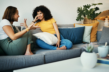 Image showing Women, friends and conversation in a home with gossip, discussion and happy in a living room. Couch, smile and people on a sofa with gossip or social together in a house lounge with speaking together