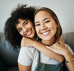 Image showing Lesbian, couple and portrait of hug on sofa in home, living room or apartment with love, support and happiness. Lgbt, women or relax together on couch with pride, confidence smile in embrace in house