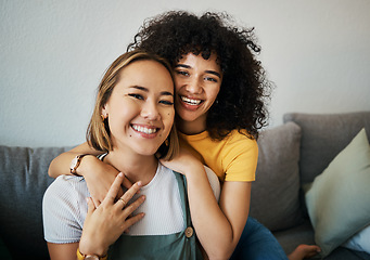 Image showing Lesbian, couple and portrait of hug on sofa in home, living room or apartment with love, support and happiness. Lgbt, women and embrace together with smile on face on lounge, relax and couch in house