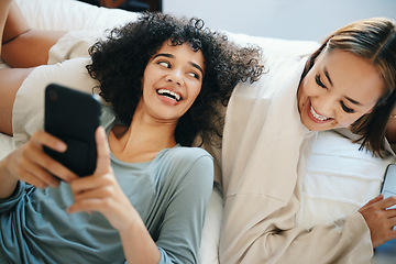 Image showing Home, lesbian couple and women with a phone, digital app and typing with social media, relax and romance. Communication, queer people and happy girls with a cellphone, mobile user and meme with post