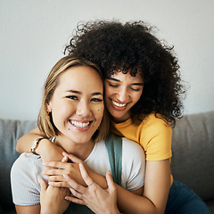 Image showing Lesbian, couple and portrait of hug on sofa in home, living room or apartment with love, support and happiness. Lgbt, women and relax together with pride, confidence and smile on face in house