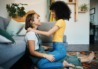 Image showing Lesbian, couple and women relax together on floor at home, bonding with love and pride, happiness and care. Support, trust and healthy relationship, LGBTQ with smile and romance in living room