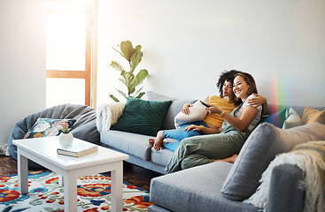 Image showing Love, relax and a lesbian couple watching tv on a sofa in the living room of their home together. Smile, LGBT and a woman with her girlfriend enjoying a movie on a subscription streaming service