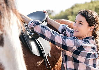 Image showing Horse, happy rider and woman with saddle on ranch for animal care, training and riding on farm. Agriculture, countryside and person with seat for stallion for practice, freedom and adventure outdoors