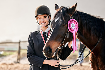 Image showing Portrait, equestrian and a woman winner with an animal on a ranch for sports, training or a leisure hobby. Smile, award or prize ribbon and a happy young rider in uniform with her stallion outdoor