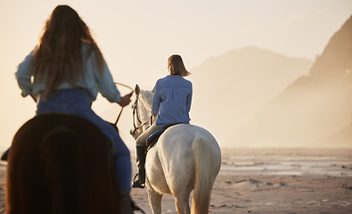 Image showing Woman, horse riding and activity at beach, together and back view for exercise, wellness or health. Female, person or friends with workout on vacation, holiday and traveling at sunset for self care