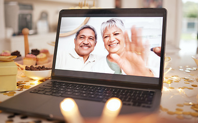 Image showing Senior couple, laptop screen and video call on table at party, event or dinner by candle, glitter or wave. Elderly man, woman and hello with smile, contact or webinar for chat for happy birthday wish