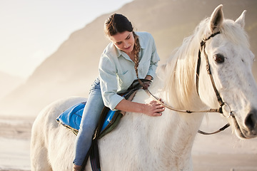 Image showing Beach, equestrian and woman riding her horse outdoor on a summer morning for training or practice. Nature, sunset and a young rider on horseback with her pet animal by the ocean or sea to relax