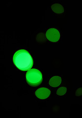 Image showing Green light, bokeh and glow on dark background on a mockup space. Blur, black backdrop and defocused shine, sparkle or abstract glitter at night for Christmas, holiday or party with magic color dots