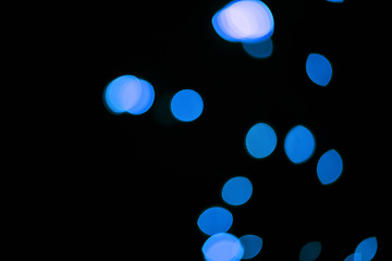 Image showing Bokeh, blue dots and dark background with glow or sparkle, mockup space with light, texture and flare from festival. Glitter, art and texture with graphic design, special effects on black backdrop