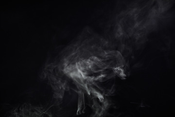 Image showing Smoke, black background and mist, fog or gas on mockup space wallpaper. Cloud, smog and magic effect on dark backdrop of steam with abstract texture, pollution pattern or incense vapor moving in air