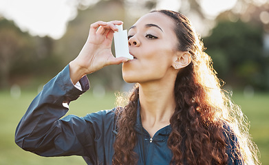 Image showing Health, woman and asthma pump outdoor to breathe on sports field in nature for lungs risk or breathing. Fitness, person and hand holding inhaler for wellness, relief and oxygen for prescription